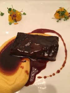 Photo of Braised Short Rib with Wine Reduction and Sweet Potato Puree at R'evolution Restaurant New Orleans.