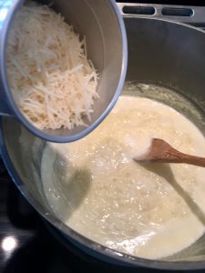 Photo of adding cheese to the butter and cram mixture.