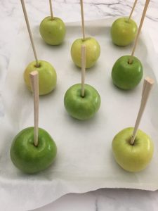 Photo of apples with sticks. 