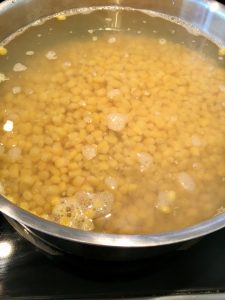 Photo of corn in simmering water. 