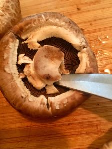 Photo of prepping mushrooms to be stuffed.