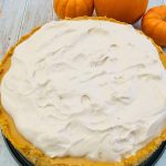 Photo of Pumpkin Cheesecake with Spiced Whipped Cream Frosting.