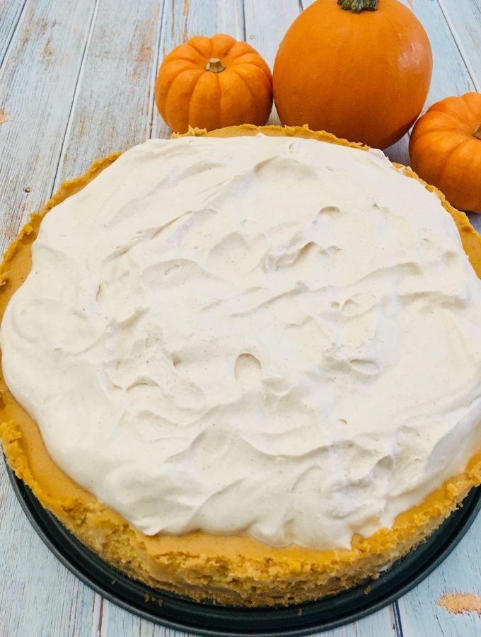 Photo of Pumpkin Cheesecake with Spiced Whipped Cream Frosting.