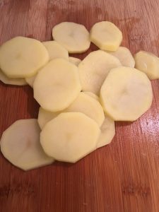 Photo of peeled and sliced Yukon Gold Potatoes.