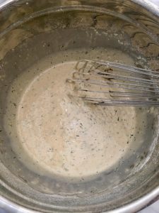Photo of whisking herbs into batter.