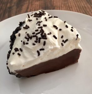 Photo of a slice of chocolate cream pie.