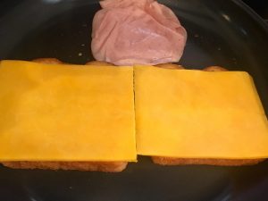 Photo of making grilled ham and cheese sandwiches.