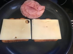 Photo of making grilled ham and cheese sandwiches.