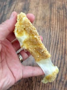 Photo of stretched out mozzarella stick. 