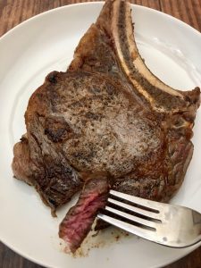 Photo of medium rare rib eye steaks.