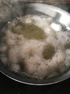 Water boiling with potatoes.