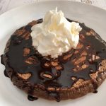 Chocolate Pancake with chocolate syrup and whipped cream.