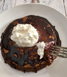 Chocolate Pancake with plenty of chocolate syrup and whipped cream.