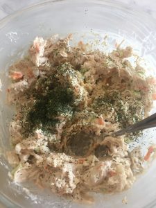 Stirring spices into chicken salad.