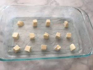 Photo of buttered baking dish with extra butter.