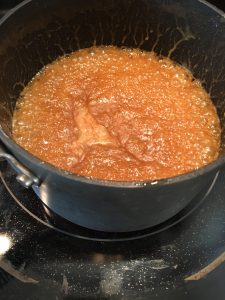 Photo of Vanilla-Bourbon Caramel Sauce cooking in a saucepan.