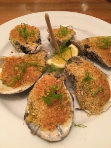Photo of the Fire Grilled Oysters at R'evolution Restaurant in New Orleans. 