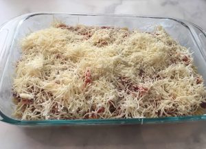 Photo of pasta with shredded mozzarella.