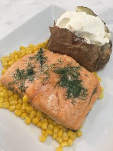Photo of baked salmon with sides. 