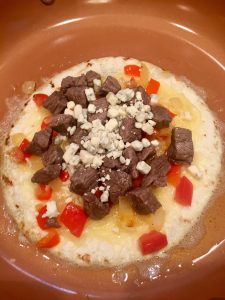 Photo of tortilla with steak and blue cheese. 