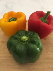 Photo of different colored bell peppers.