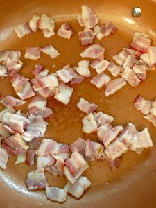 Photo of bacon cooking.