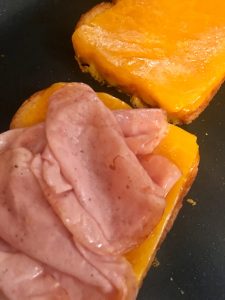 Photo of making grilled ham and cheese breakfast sandwiches.