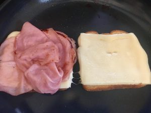 Photo of making grilled ham and cheese sandwiches. 