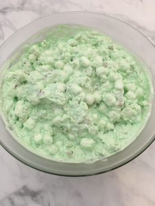 Photo of making of lime jello fluff salad.
