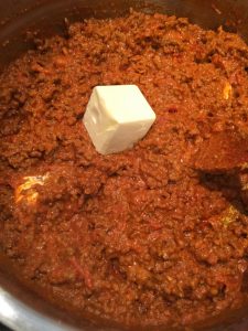 Add butter to the meat sauce.