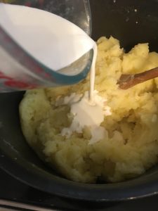 Add cream to the mashed potatoes. 