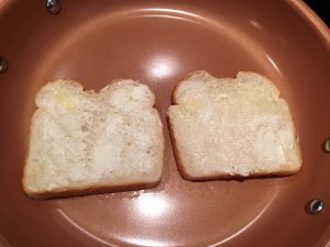 Buttered bread in a pan. 