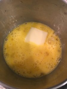 Add cold butter to whisked eggs.