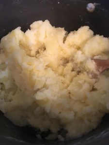 Mashing potatoes.