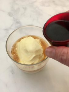 Pouring espresso over ice cream to make an affogato.