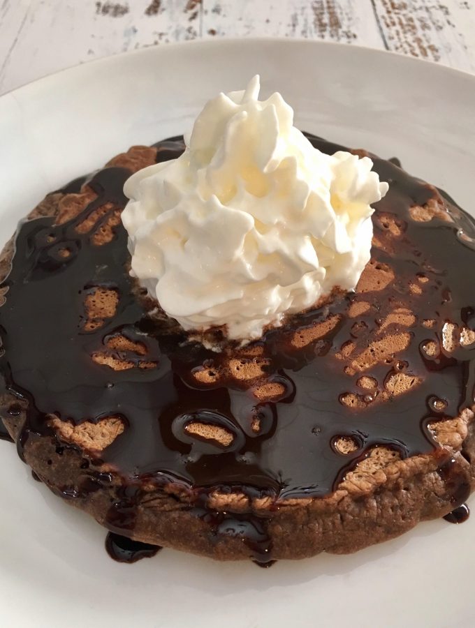 Chocolate Pancake with chocolate syrup and whipped cream.