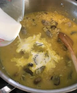 Cream being added to oyster rice.