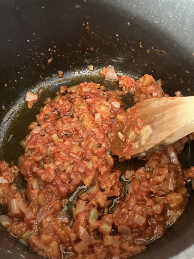 Tomato paste cooking with vegetables. 