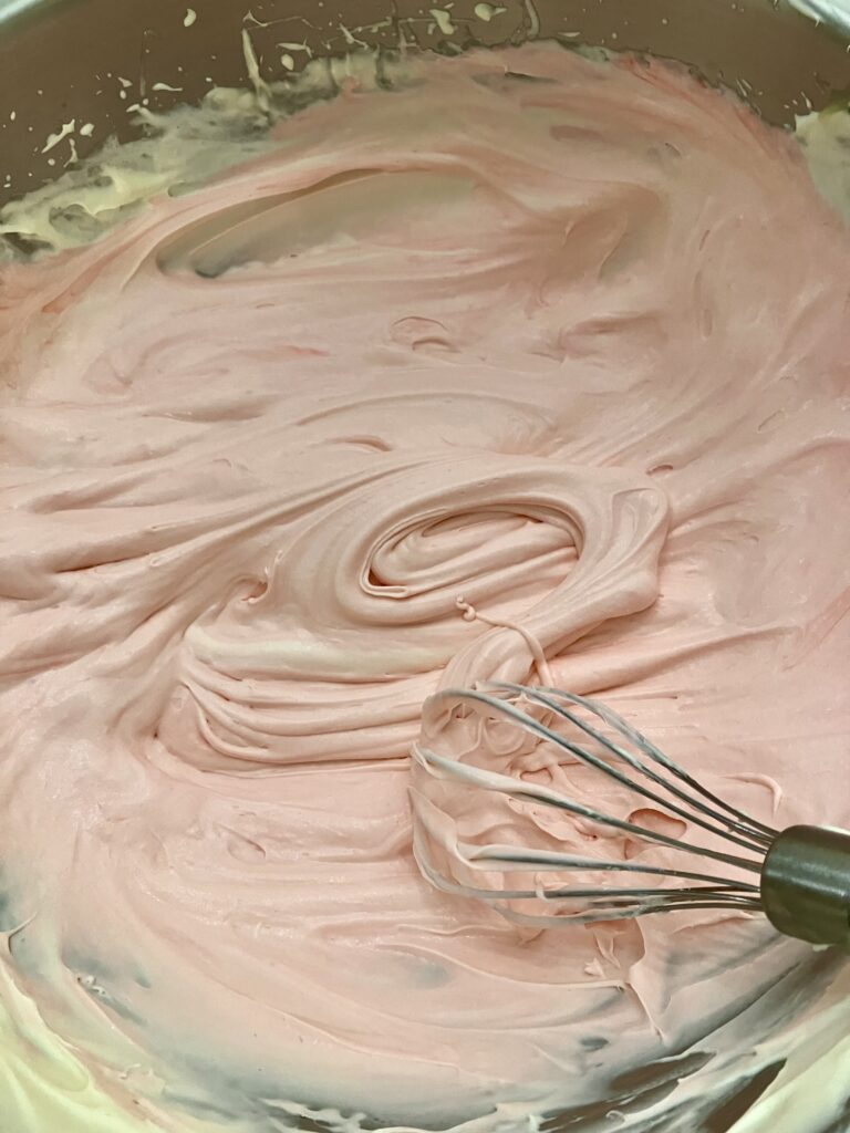 Added pink food coloring to ice cream base. 
