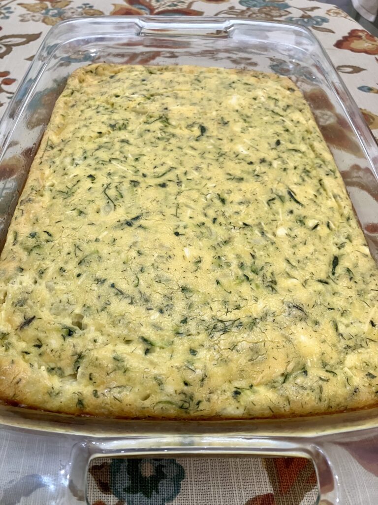 Sfougato is a Greek zucchini, feta cheese, and egg breakfast dish that is baked in the oven. 