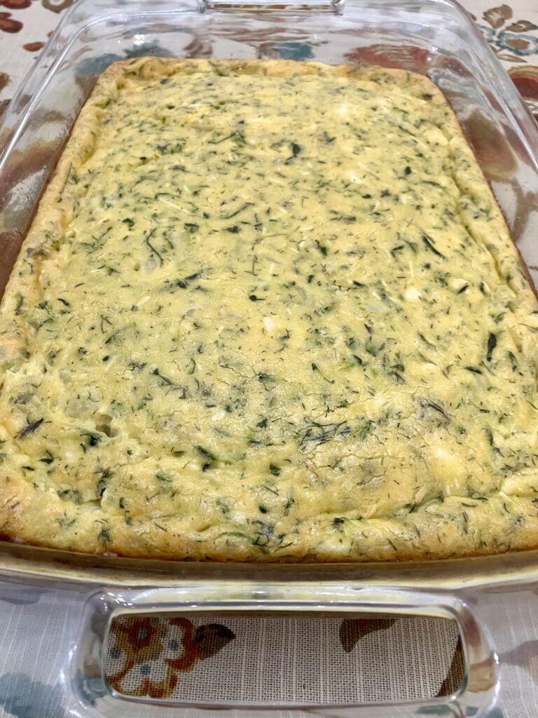 Sfougato is a Greek zucchini, feta cheese, and egg breakfast dish that is baked in the oven.  It's similar to a crustless quiche.