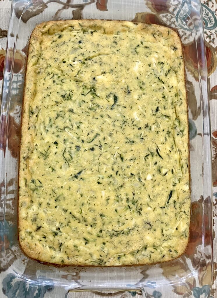 Sfougato is a Greek zucchini, feta cheese, and egg breakfast dish that is baked in the oven.  It's similar to a crustless quiche.