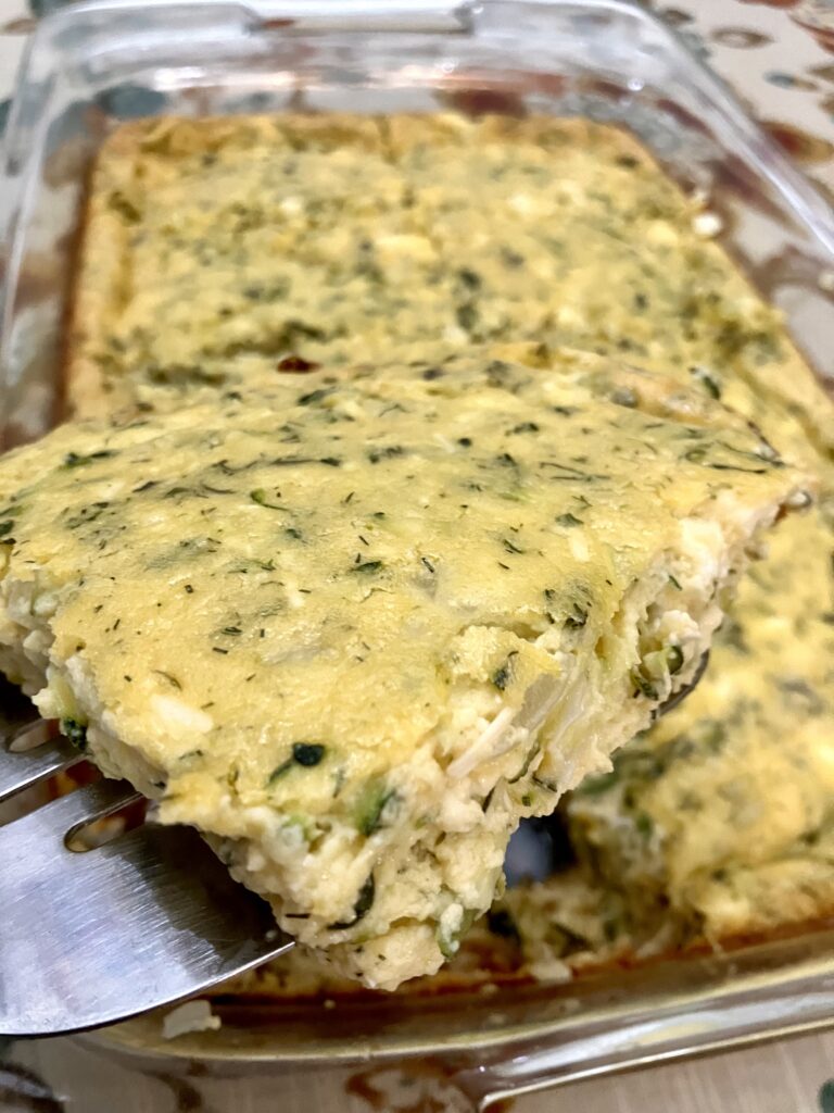 Sfougato is a Greek zucchini, feta cheese, and egg breakfast dish that is baked in the oven.  It's similar to a crustless quiche.