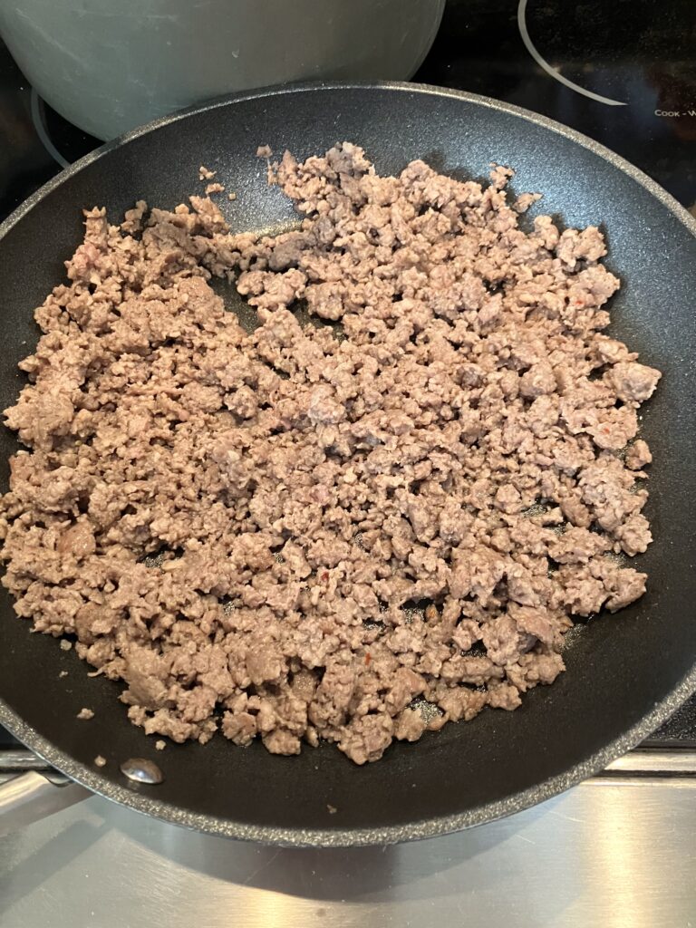 Ground sausage in a pan. 