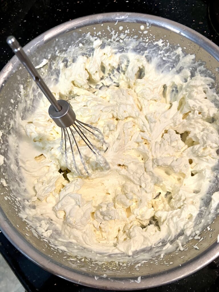 Whipped heavy cream with powdered sugar. 