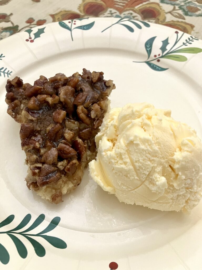 Pecan Upside Down Cake with a scoop of vanilla ice cream.