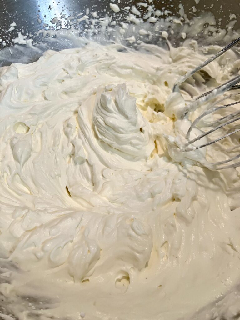 Heavy whipping cream beaten to stiff peaks with confectioners (powdered) sugar. 