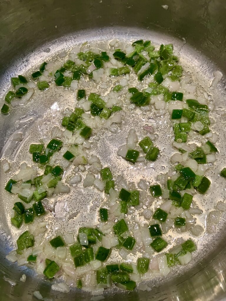 Jalapeños and shallots cooking in butter.